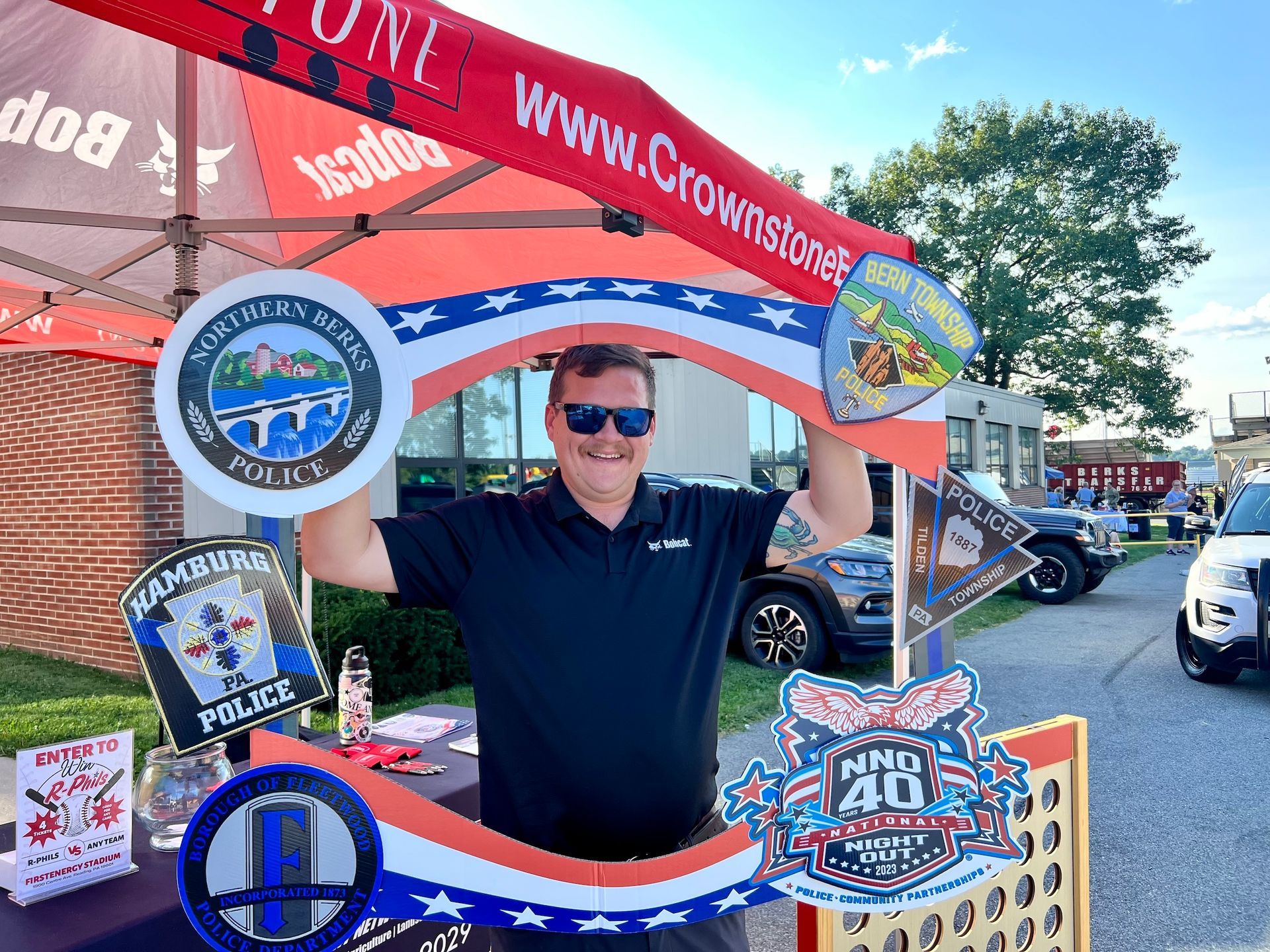 A man is standing in front of a sign that looks like a key.