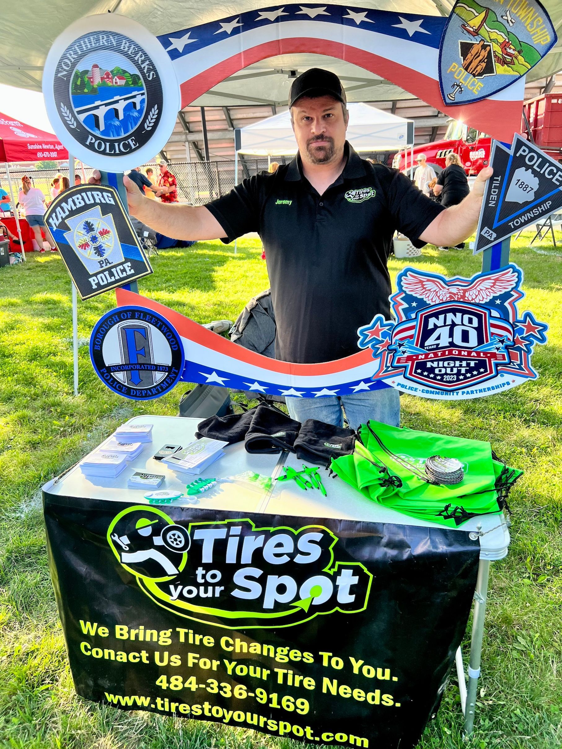 A man is standing in front of a table that says tires to your spot.