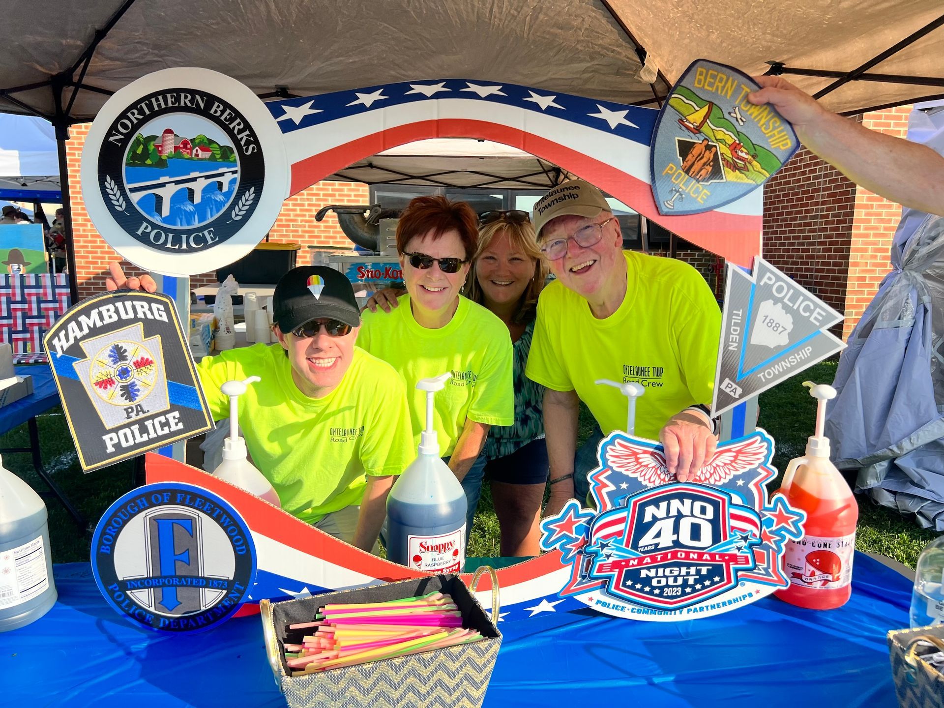 A group of people standing around a table with a sign that says police