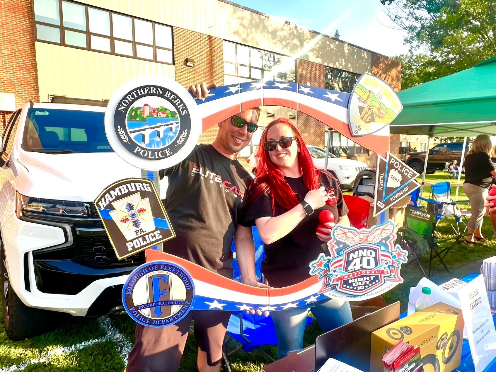A man and a woman are standing next to each other holding signs.