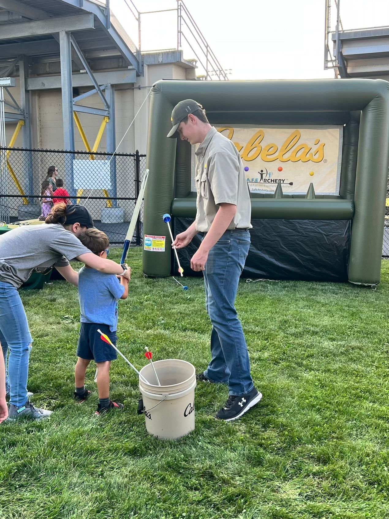 A man and a boy are playing a game of baseball in a field.