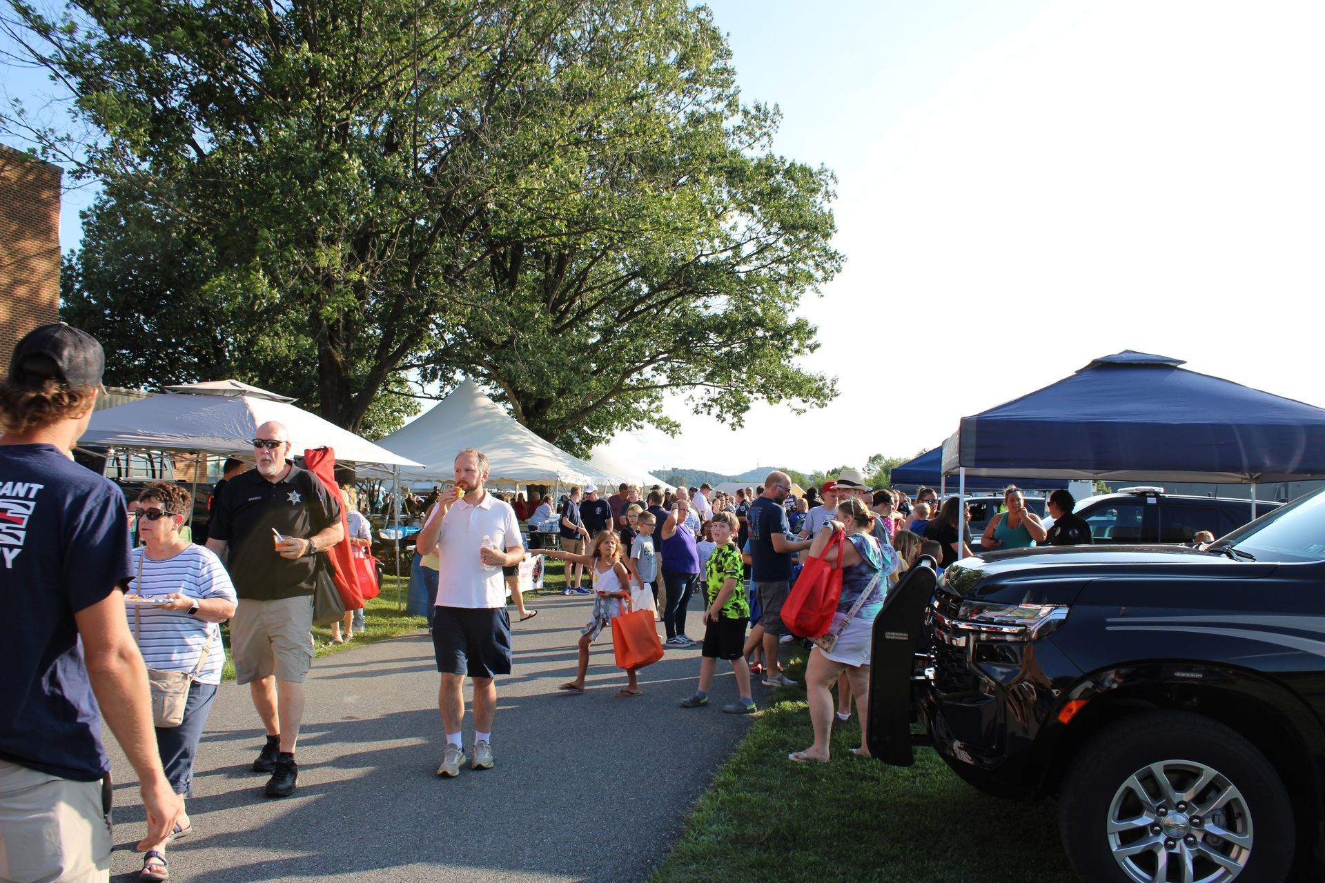 A large group of people are walking down a street.