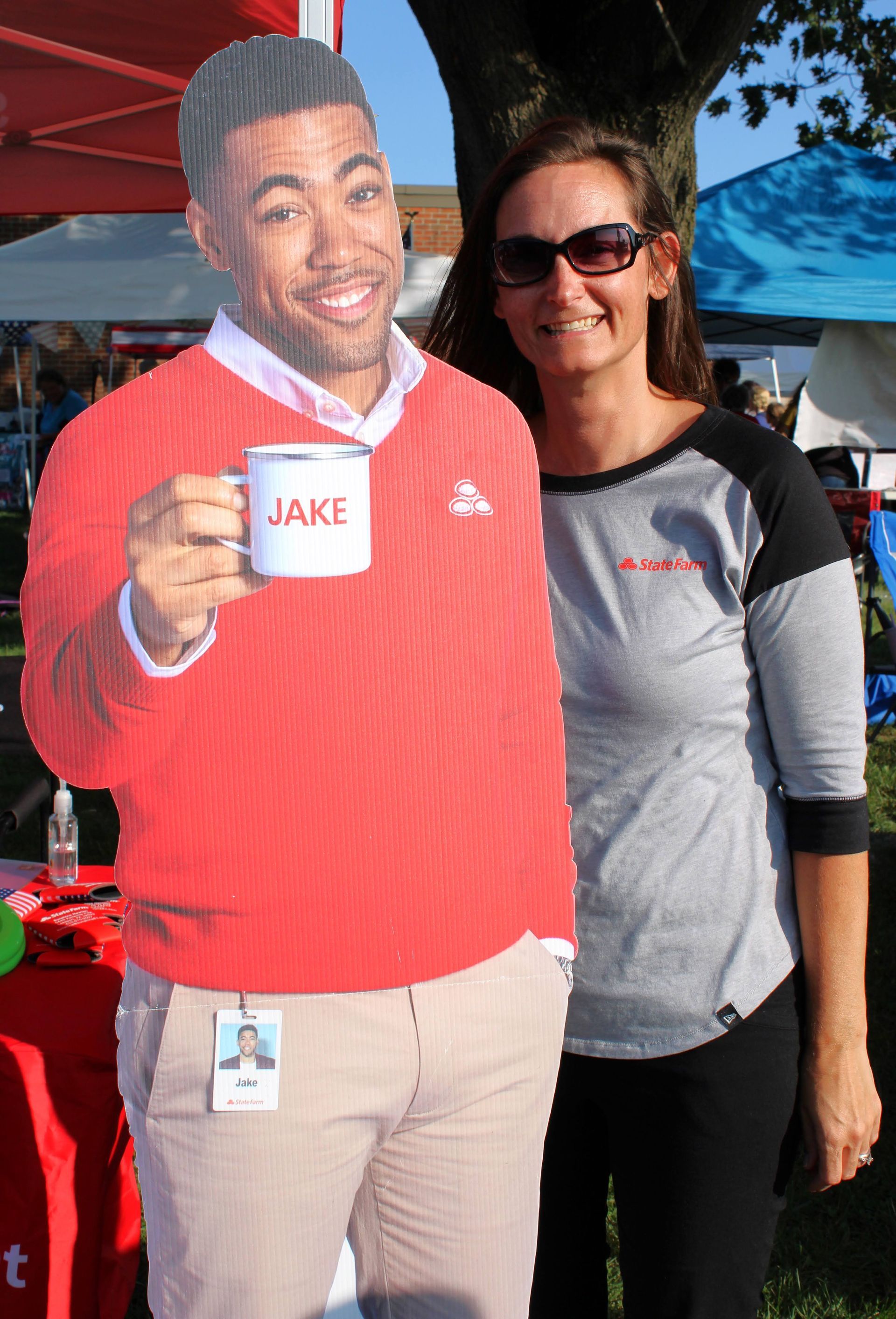 A man in a red sweater is holding a cup with the name jake on it