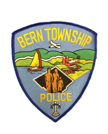 A bern township police patch with a family on it