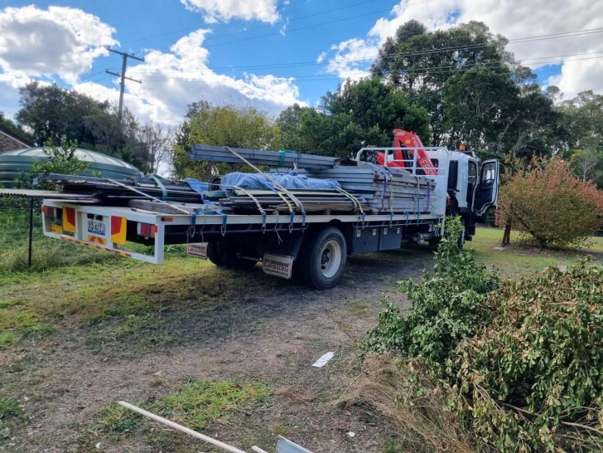 A Truck With a Crane on the Back is Parked in a Yard — BS Crane Truck and Trailer Hire In Cooroy, QLD