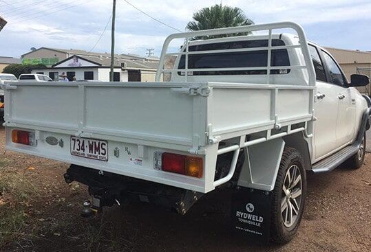 A White Truck With A Tray On The Back Is Parked In A Dirt Lot — Emerald 4x4 in Emerald, QLD