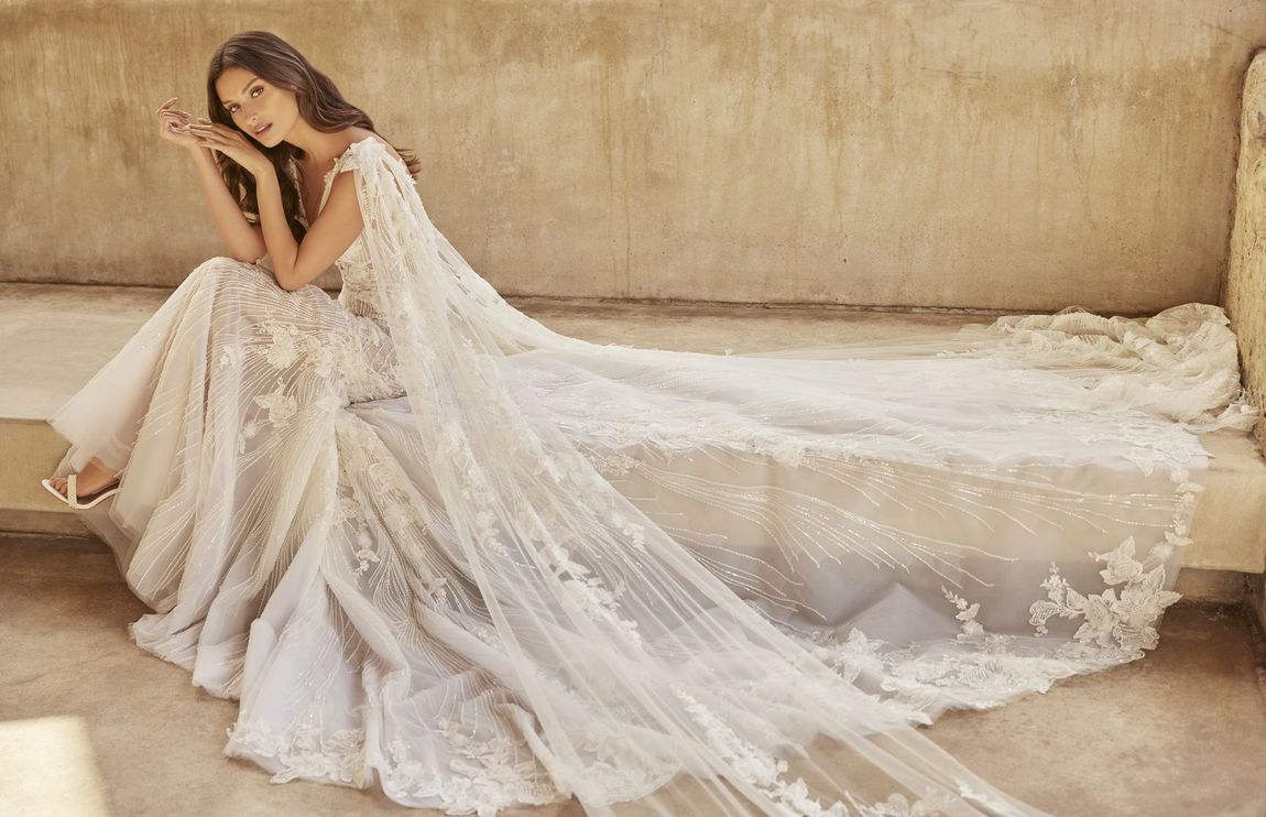 A woman in a wedding dress is sitting on a couch.