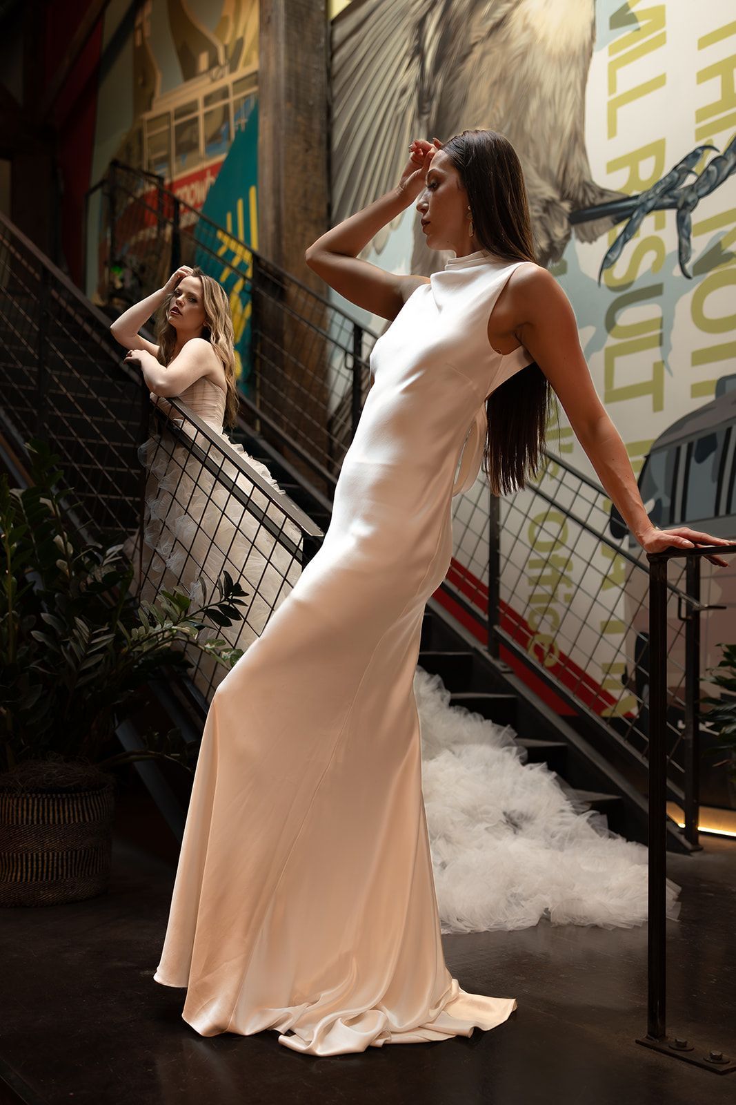 A row of white wedding dresses on mannequins in a store