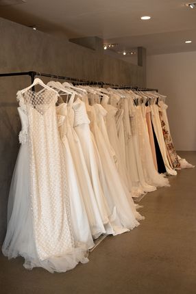 A close up of the back of a wedding dress with buttons.