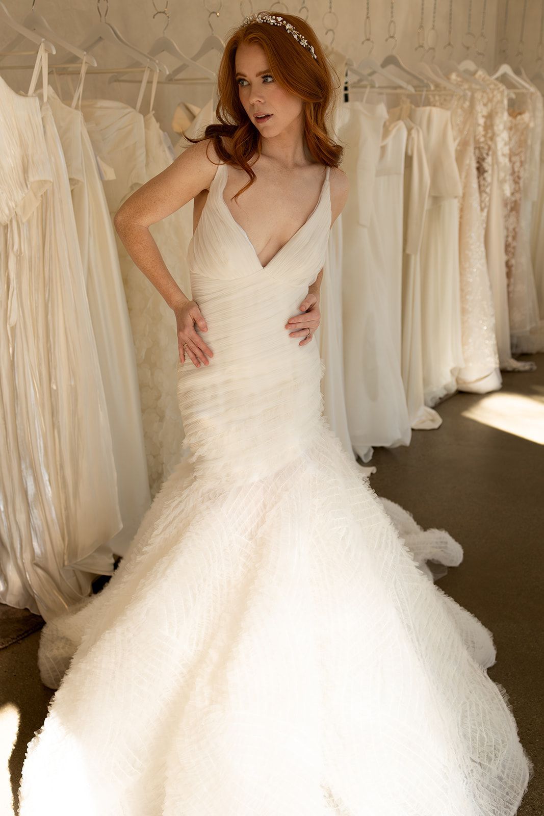 A man is working on a wedding dress in a studio.