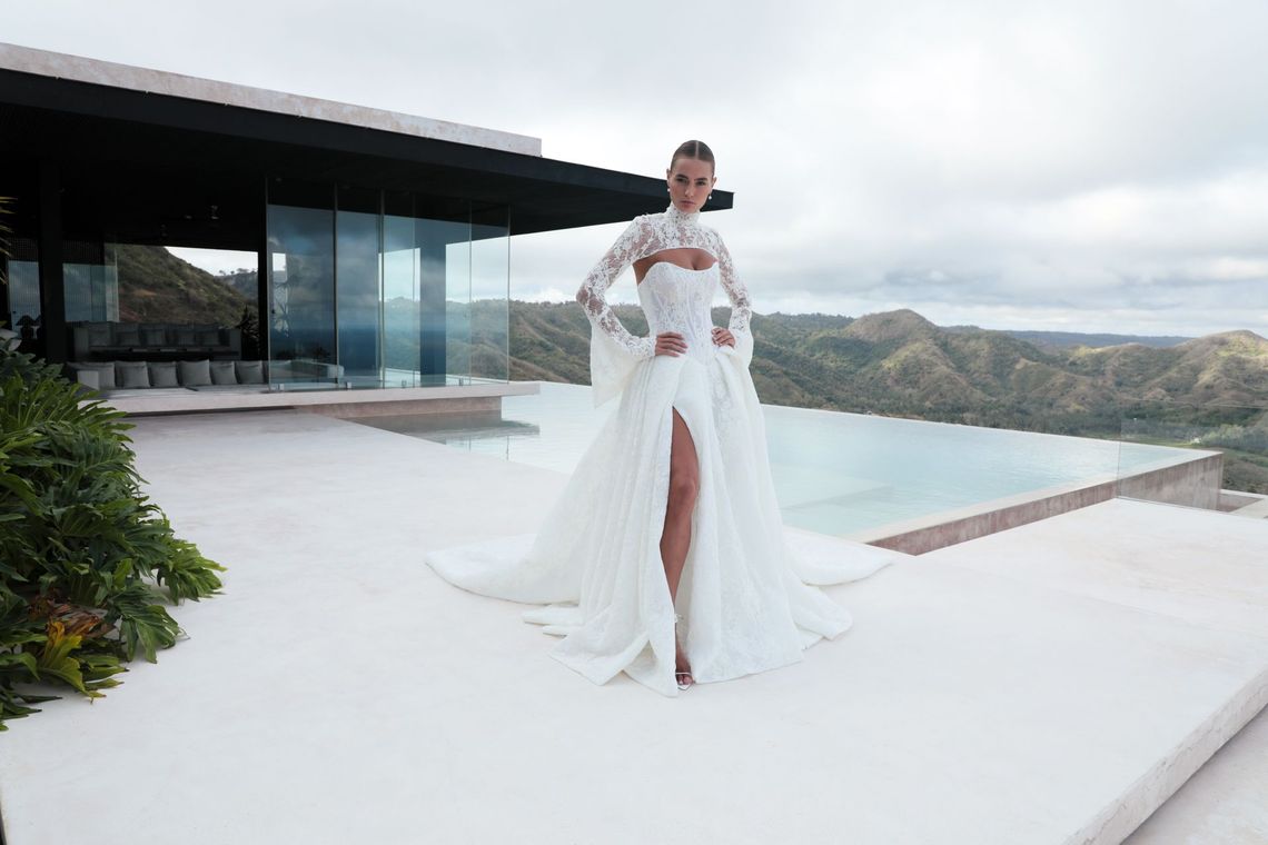 A woman in a wedding dress is sitting on a couch.