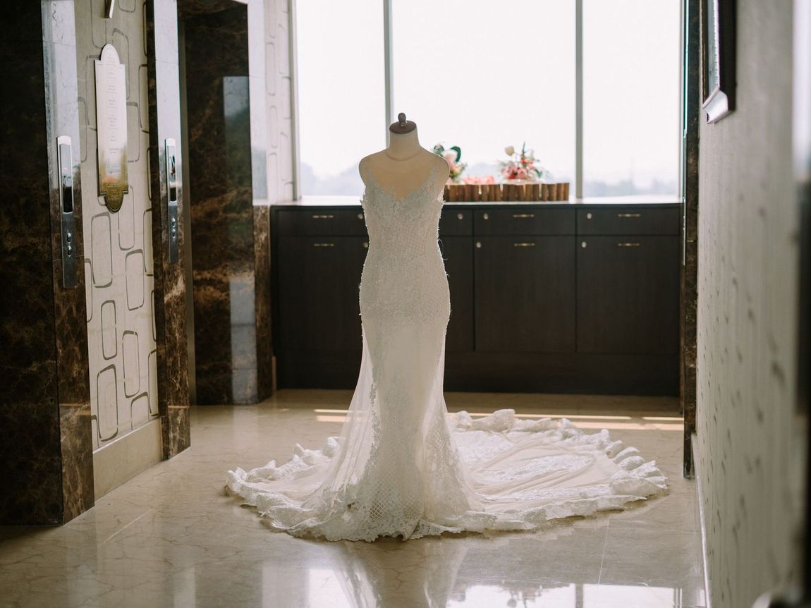 A wedding dress is on a mannequin in a hallway.