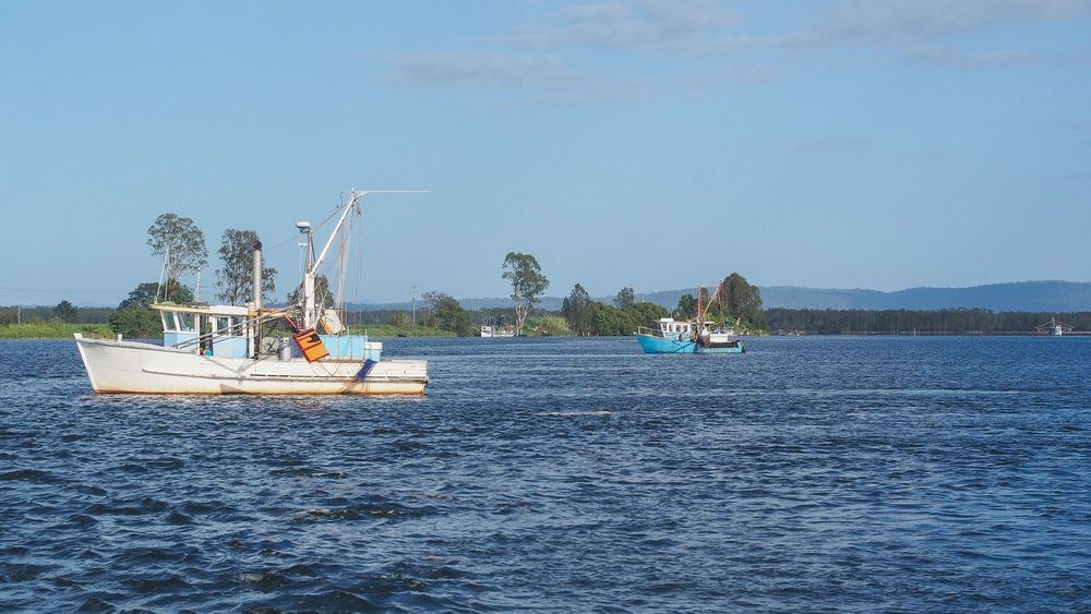 A Boat Is Floating On Top Of A Large Body Of Water — Hilldrop Motor Inn In Waterview Heights, NSW