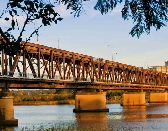 A Bridge Over A Body Of Water With Trees — Hilldrop Motor Inn In Waterview Heights, NSW