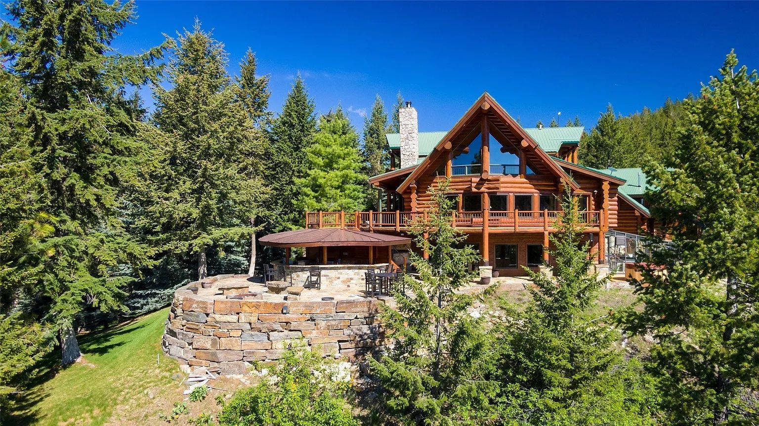 The Ridge at Flathead Lake lodge exterior with rustic stone patio, ideal for Montana weddings and retreats.