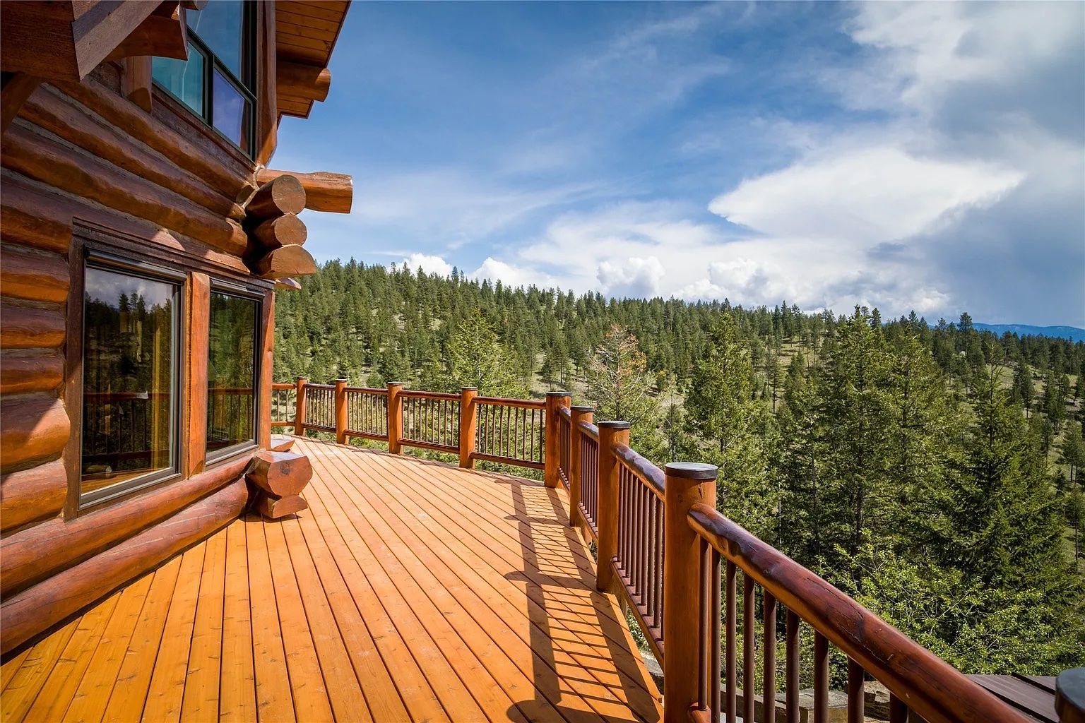 Large outdoor balcony with forest views, a scenic spot for wedding ceremonies at The Ridge at Flathead Lake.