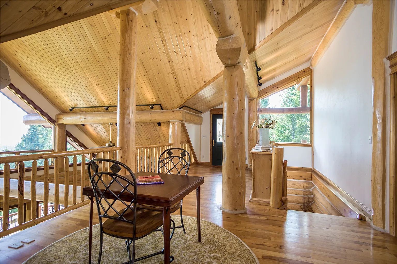 Balcony seating area in lodge with forest views, cozy spot for relaxation at The Ridge.