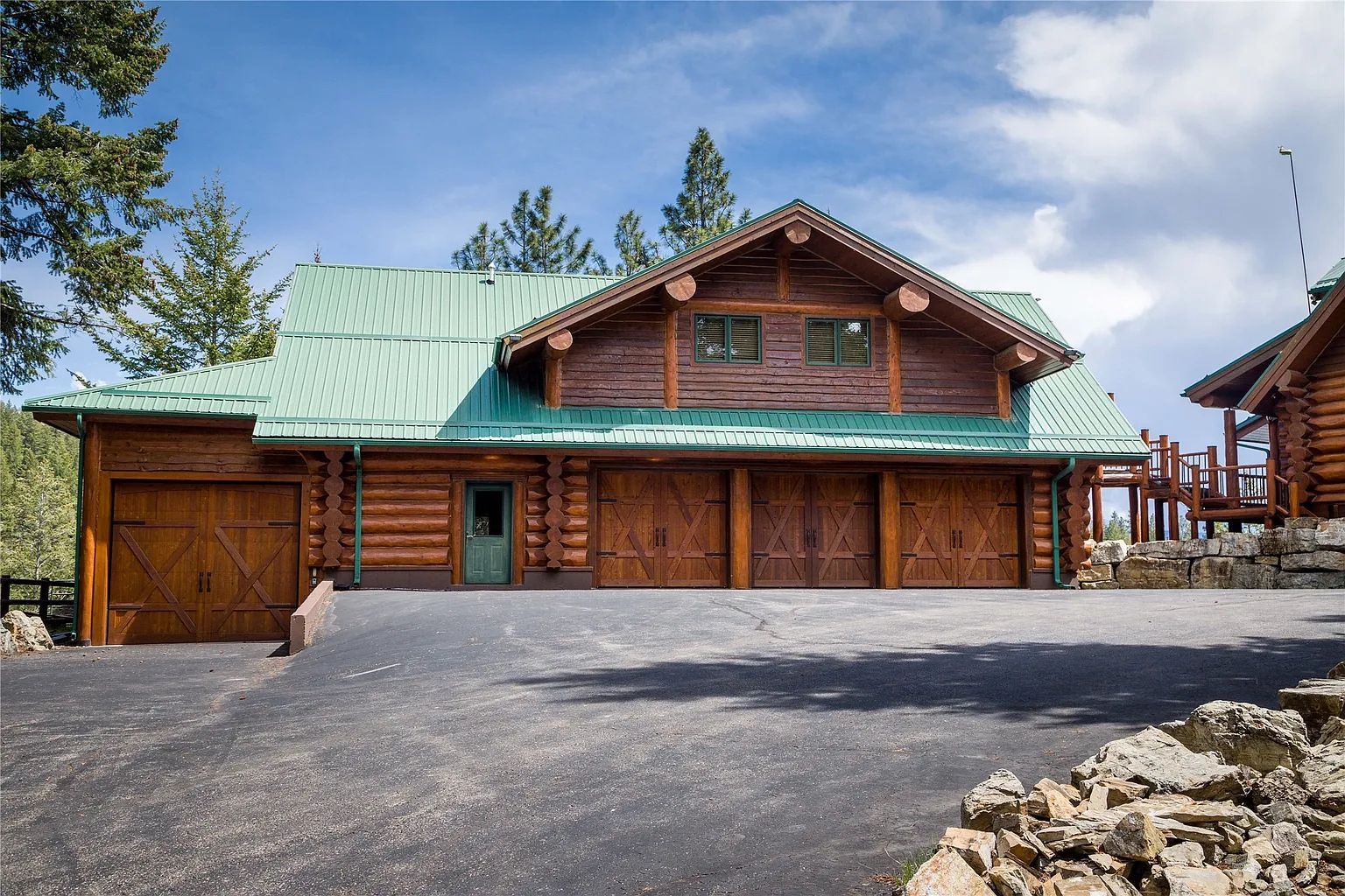 Rustic garage with green roof, part of The Ridge lodge amenities for wedding and event guests.