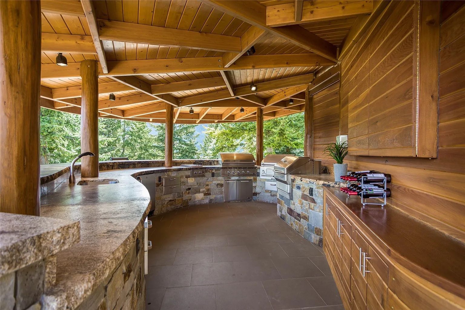 Outdoor grill and bar area with scenic forest views, ideal for outdoor gatherings at The Ridge lodge.