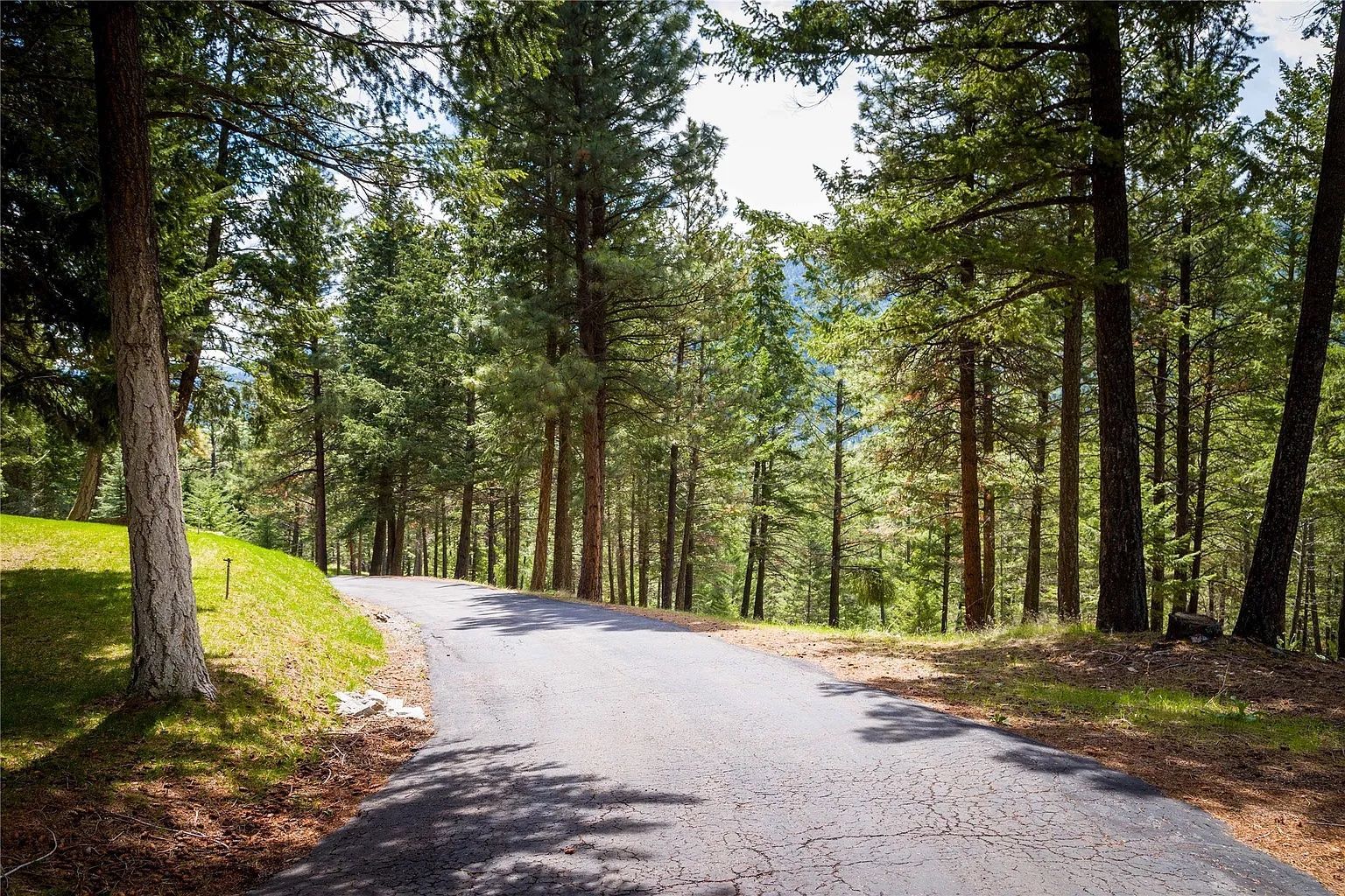 Paved road leading to The Ridge at Flathead Lake, a secluded Montana destination for weddings and events.