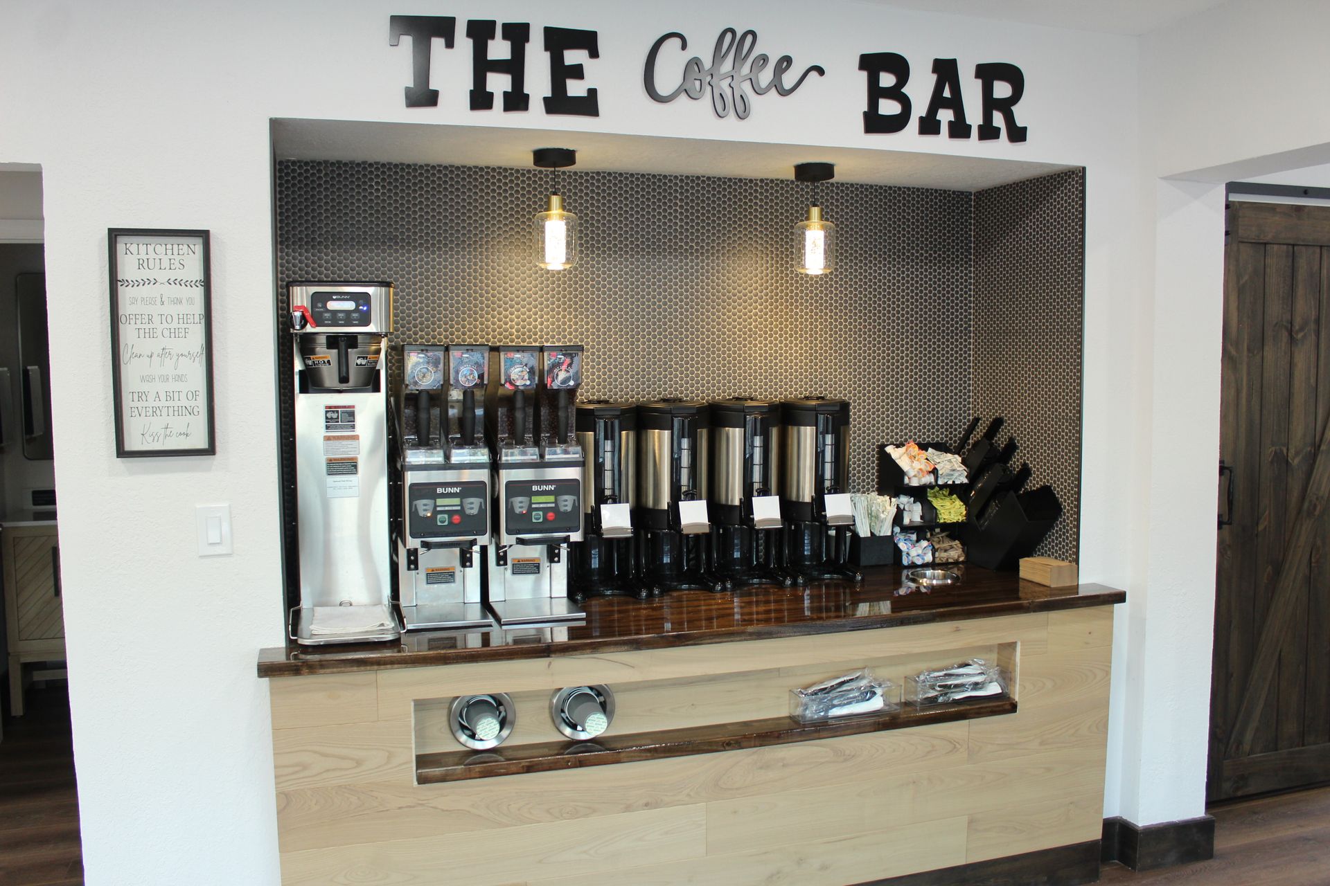 A coffee bar with a sign that says the coffee bar