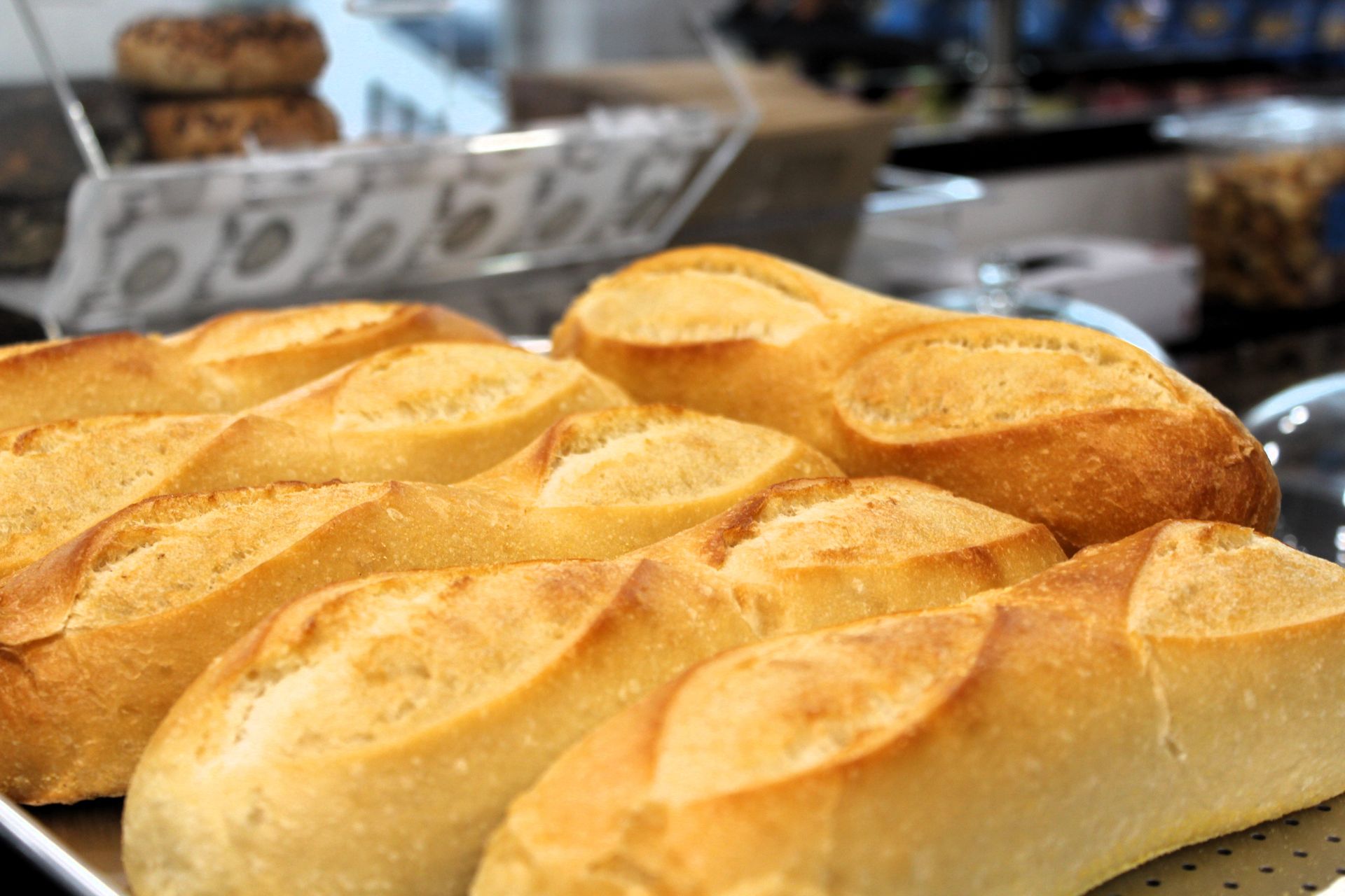 A bunch of loaves of bread are sitting on a table.