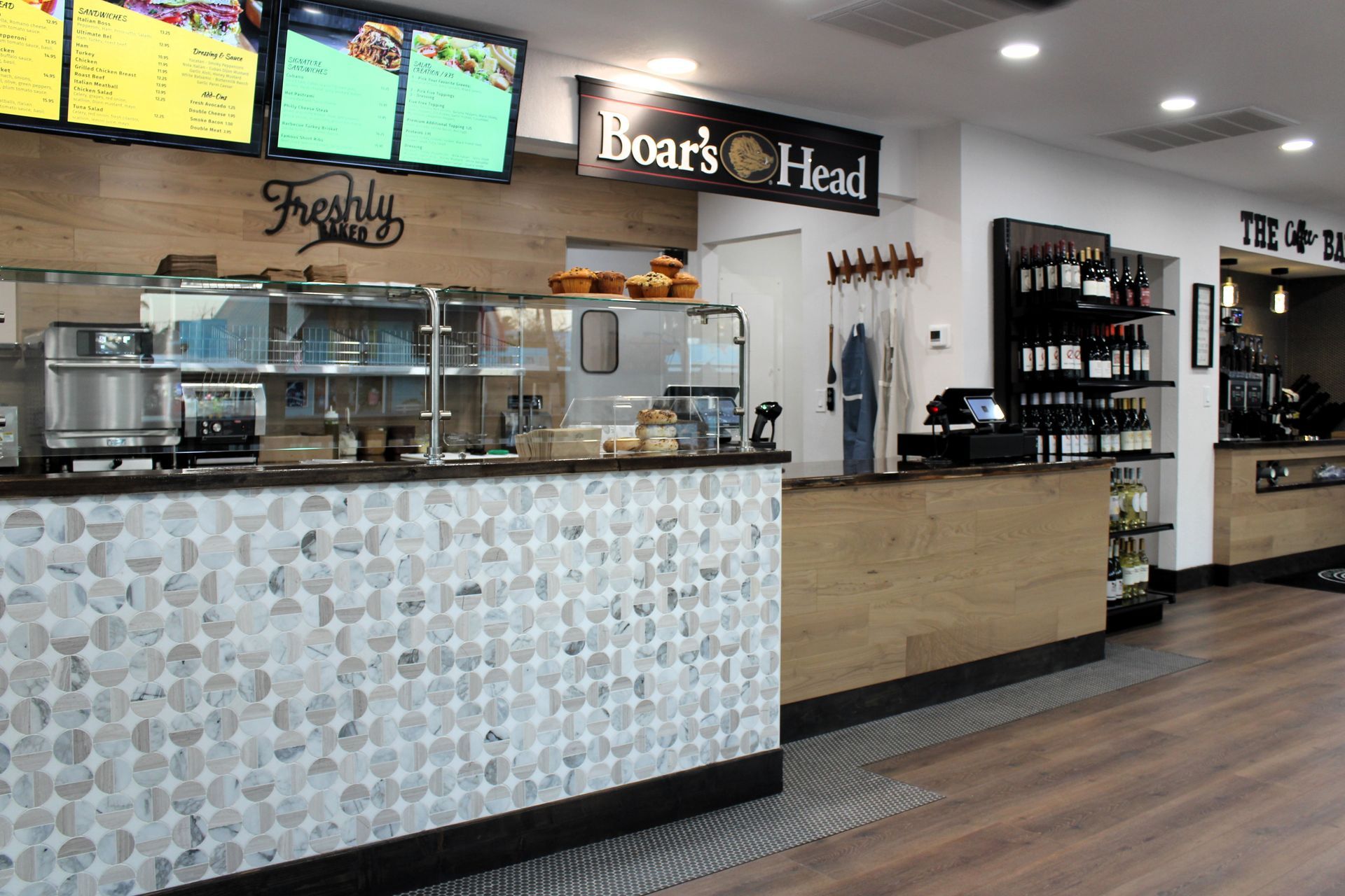 A restaurant with a counter and a sign that says boar 's head.