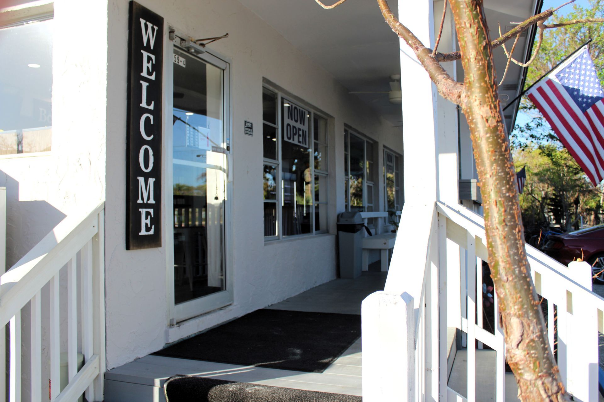 A white building with a sign that says welcome on it