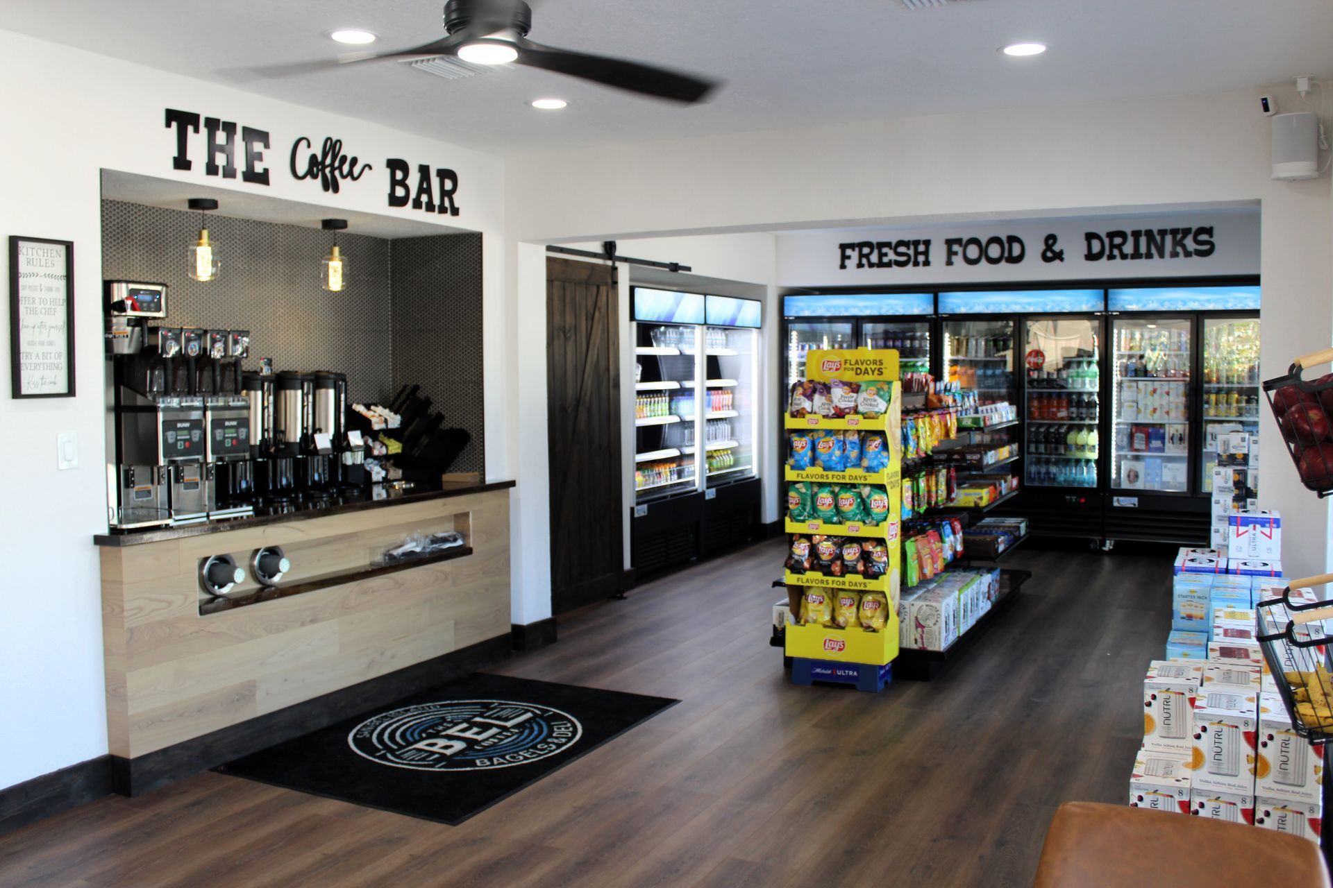 A store with a ceiling fan and a sign that says `` fresh food & drinks ''.