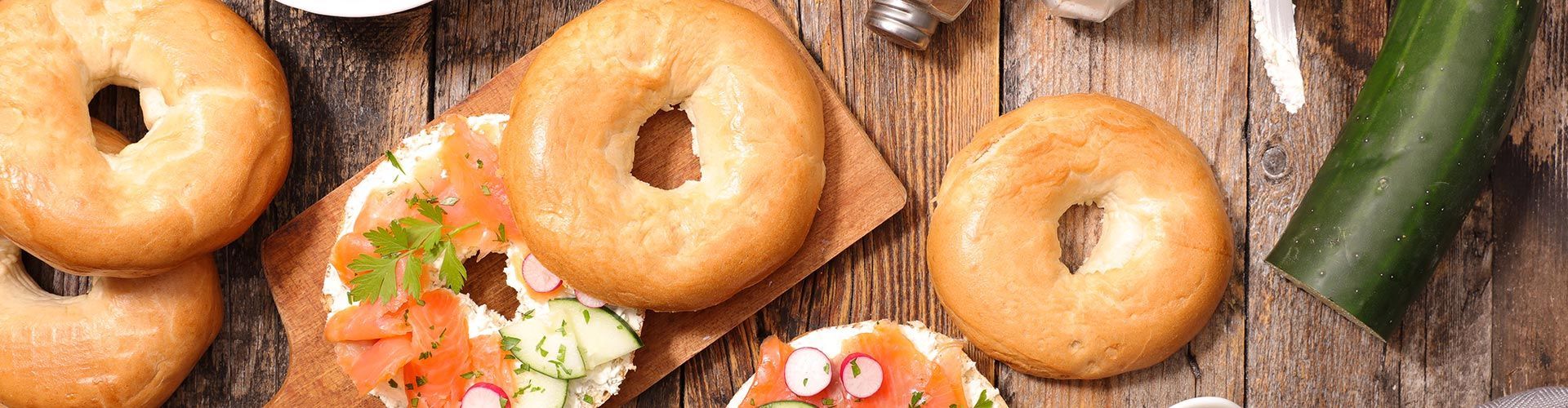 There are many different types of bagels on the table.