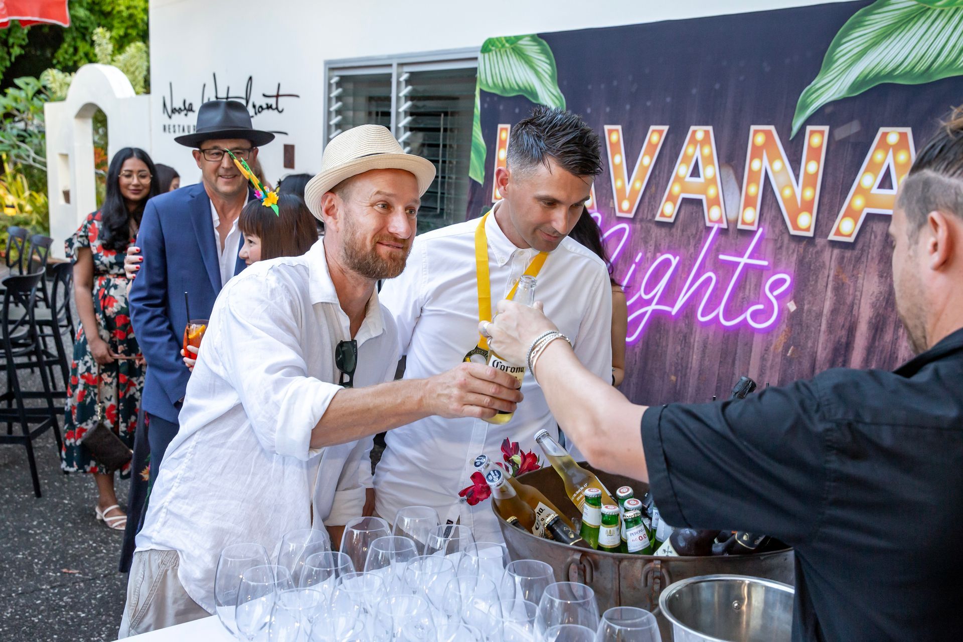 Men in white shirts toasting at a 