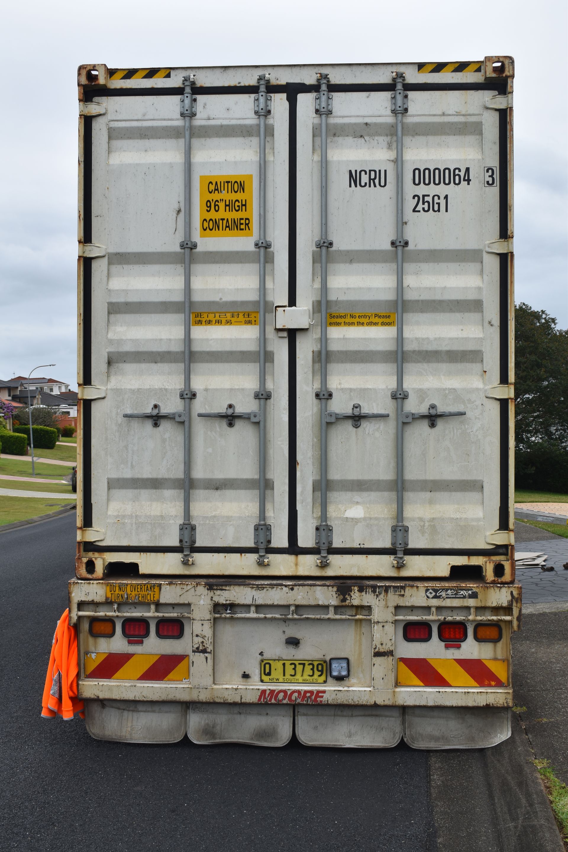 A Man And A Woman Are Sitting On A Couch Looking At A Laptop — Frontline Removals And Storage in Taree, NSW