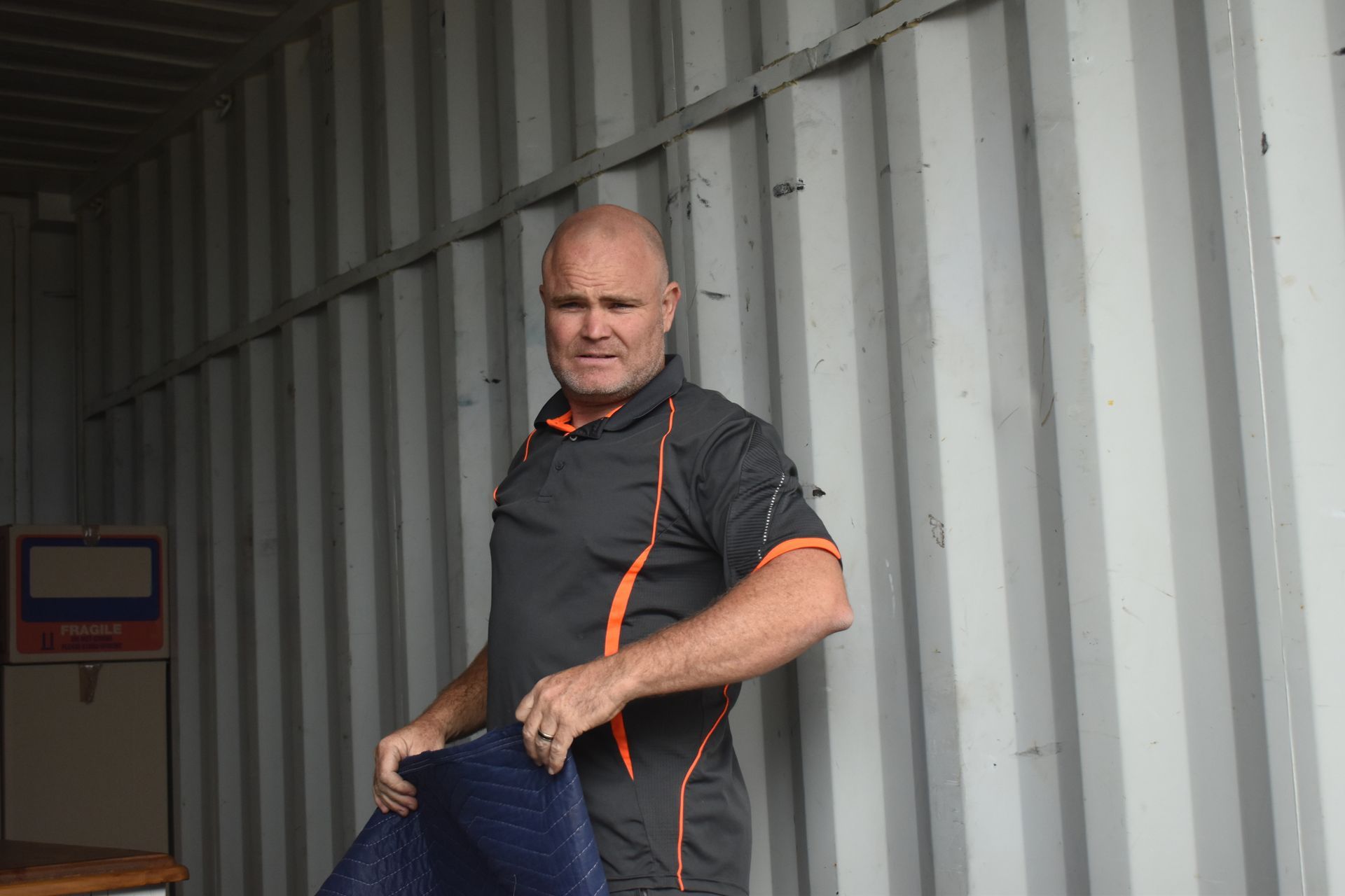 A Removalist Holding a Blanket — Frontline Removals And Storage in Wauchope, NSW