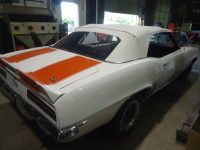 White convertible car with orange racing stripes on the trunk.