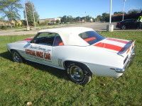 White convertible Camaro with red stripes on the back, labeled 