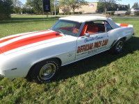 White Chevrolet Camaro convertible with red racing stripes, 