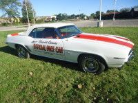 White 1969 Chevrolet Camaro convertible pace car with red stripes. 