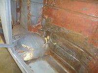 Interior car rust repair showing exposed metal.
