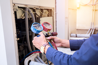 Technician is Checking Air Conditioner — Marrero, LA — Caballero's A/C & Heating