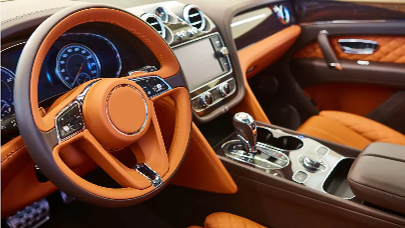 The interior of a car with a steering wheel and dashboard