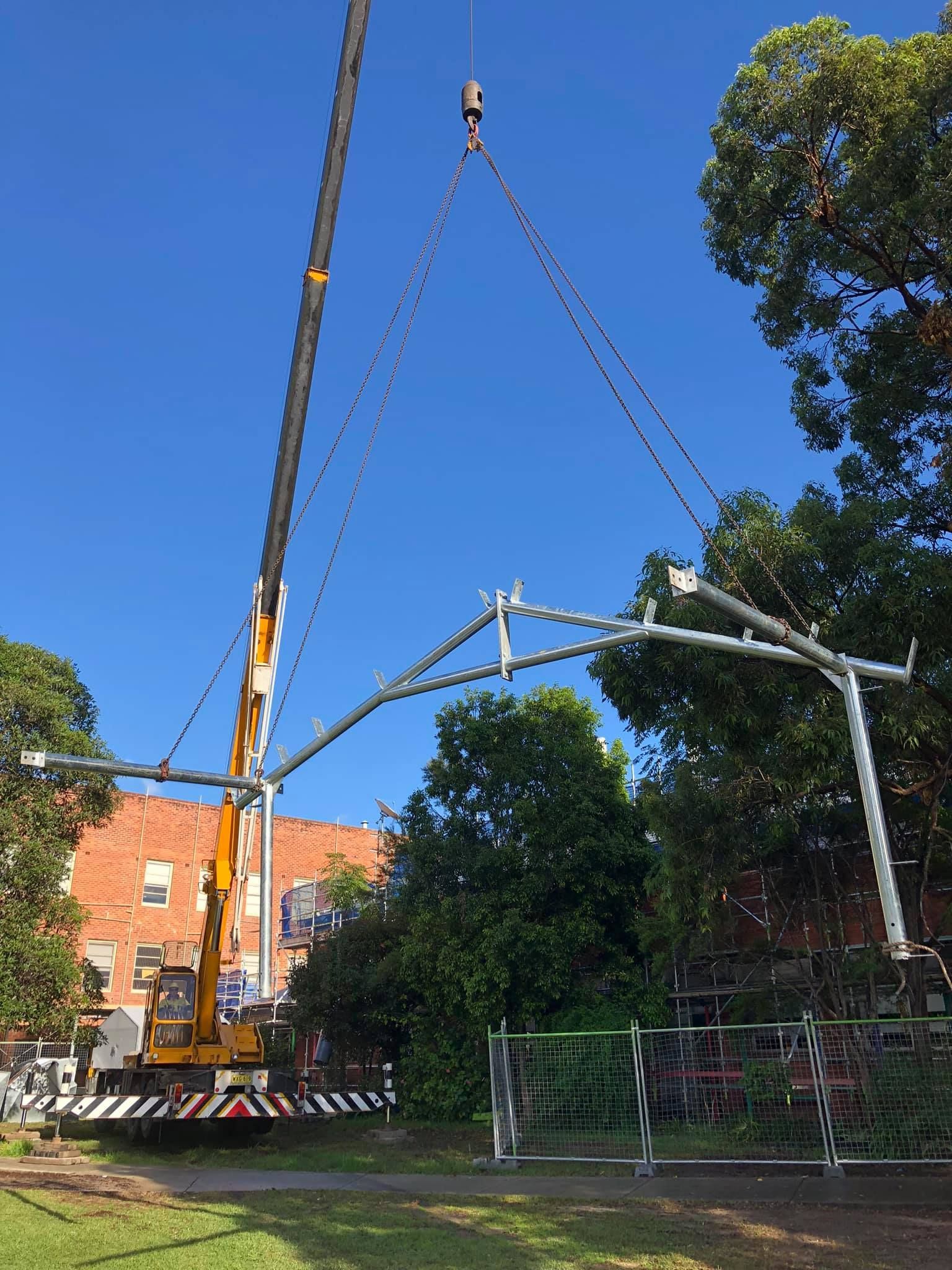 A Man Wearing a Welding Helmet is Welding a Metal Pipe — Burke Metal Fabrication In Taree, NSW
