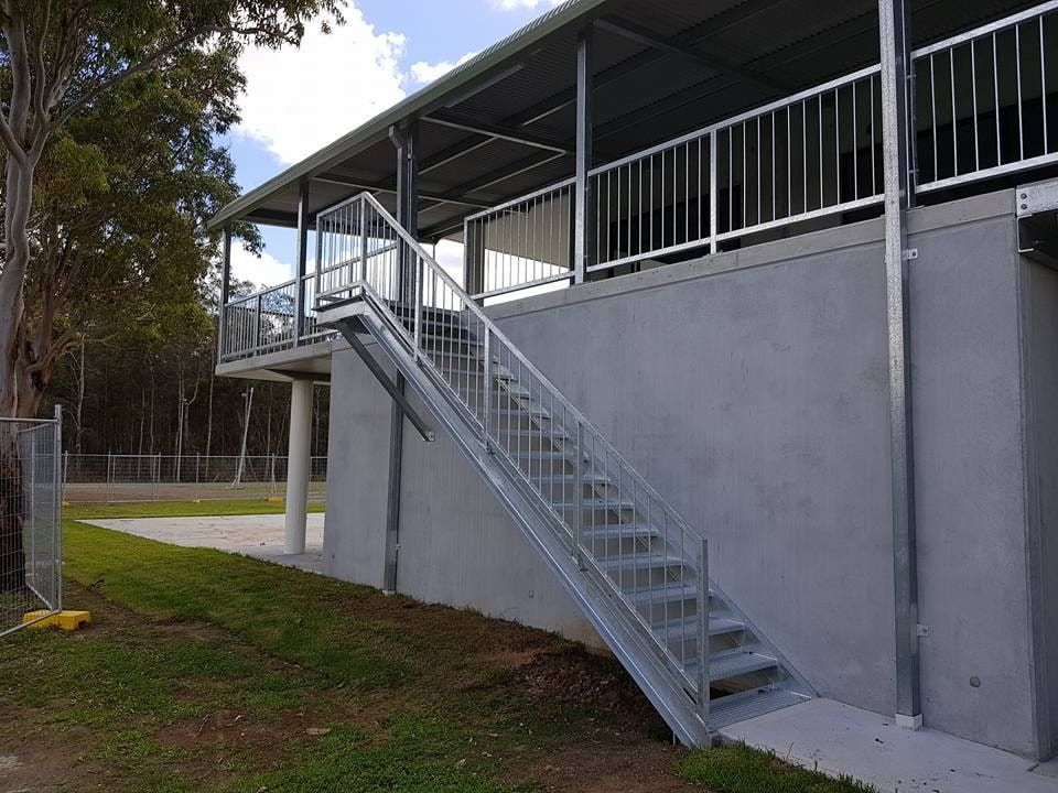 A Set of Stairs Leading Up to a Balcony on the Side of a Building — Burke Metal Fabrication In Taree, NSW