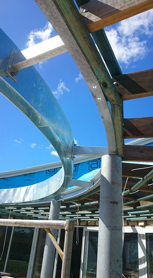 A curved featured roof steel structure is being installed— Burke Metal Fabrication In Taree, NSW