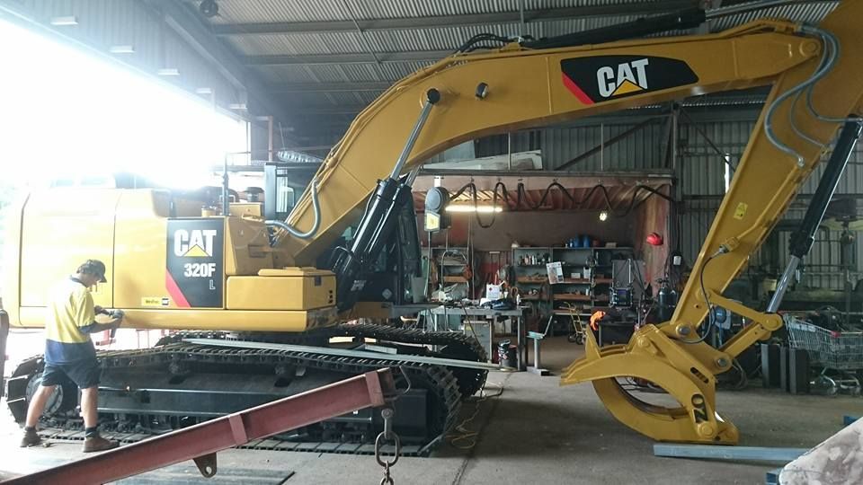A Man is Working on the Engine of a Truck — Burke Metal Fabrication In Taree, NSW
