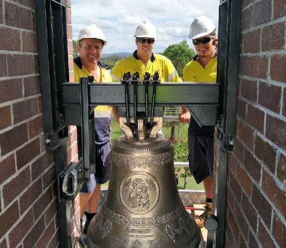A Person is Welding a Piece of Metal on a Wooden Table — Burke Metal Fabrication In Taree, NSW