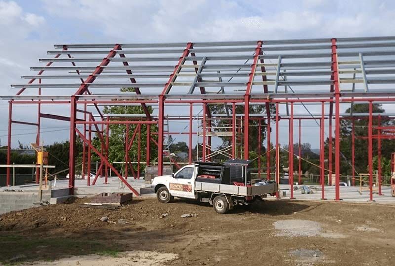 A Large Building Under Construction With a Lot of Metal Beams — Burke Metal Fabrication In Taree, NSW
