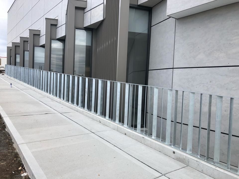 A Man is Grinding a Piece of Metal With a Grinder — Burke Metal Fabrication In Taree, NSW