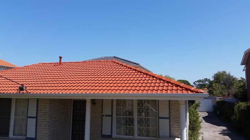restored red roof on house
