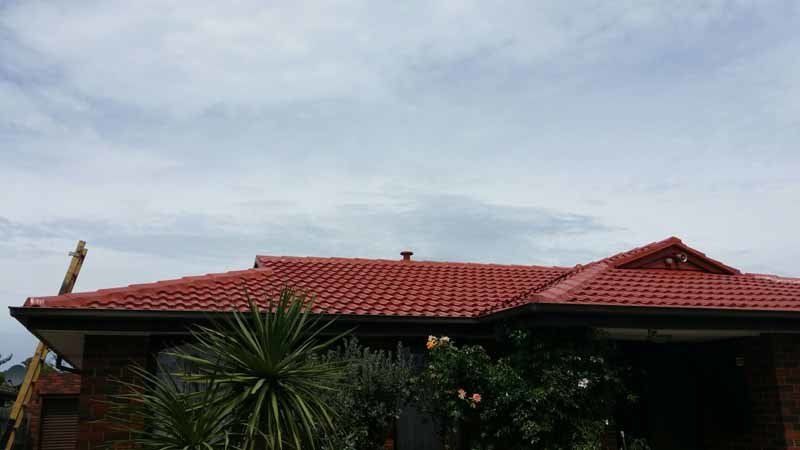 restored red roof on house