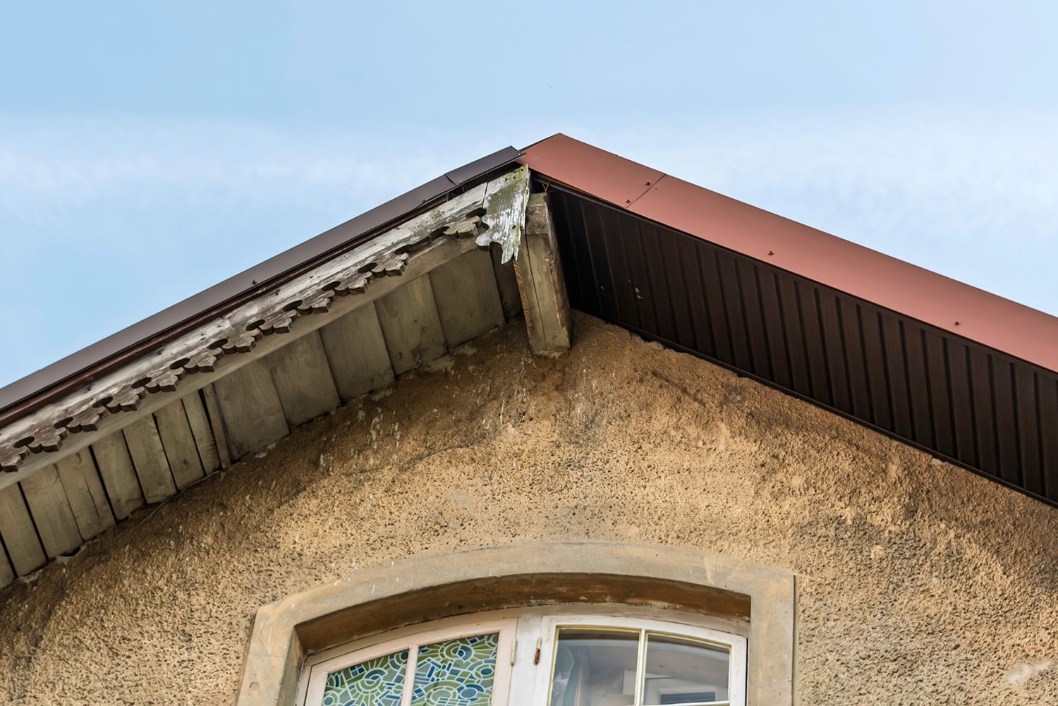 A restoration of an old roof slope with modern metal panels.
